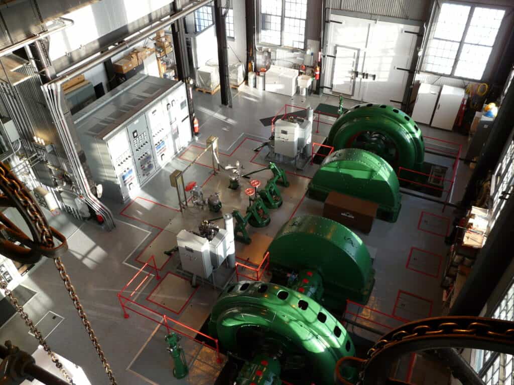 A large industrial building with green machinery.
