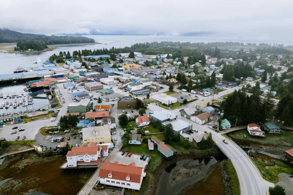 An aerial view of a small town in the middle of a coastline.